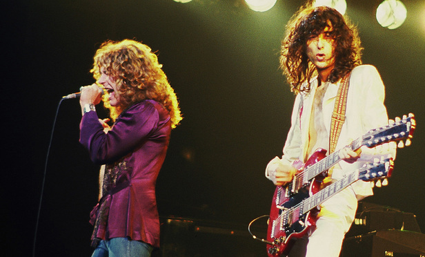 Led Zeppelin performing in concert.