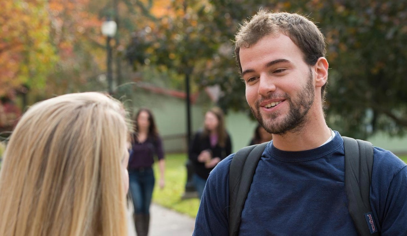 2 Widener students talking on campus.