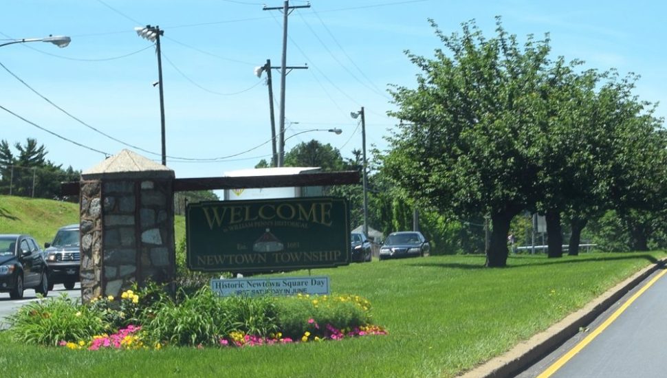 Landscape of flowers at a township welcome sign