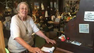 Bennie Cope, Quincy's co-owner, rings up customers on a 101-year-old wooden cash register