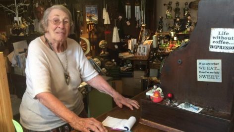 Bennie Cope, Quincy's co-owner, rings up customers on a 101-year-old wooden cash register