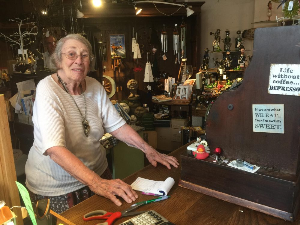 Bennie Cope, Quincy's co-owner, rings up customers on a 101-year-old wooden cash register