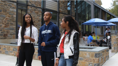 Three students at Cheyney University talk on campus.