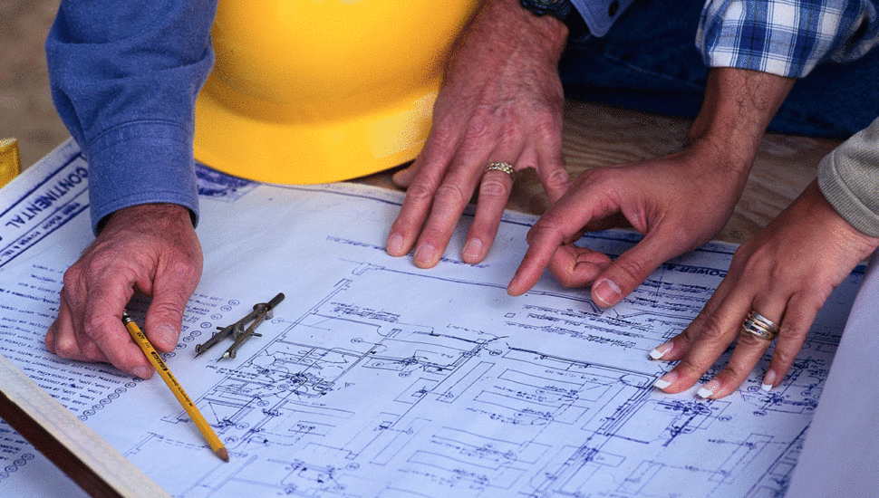 Contractors looking at a blueprint