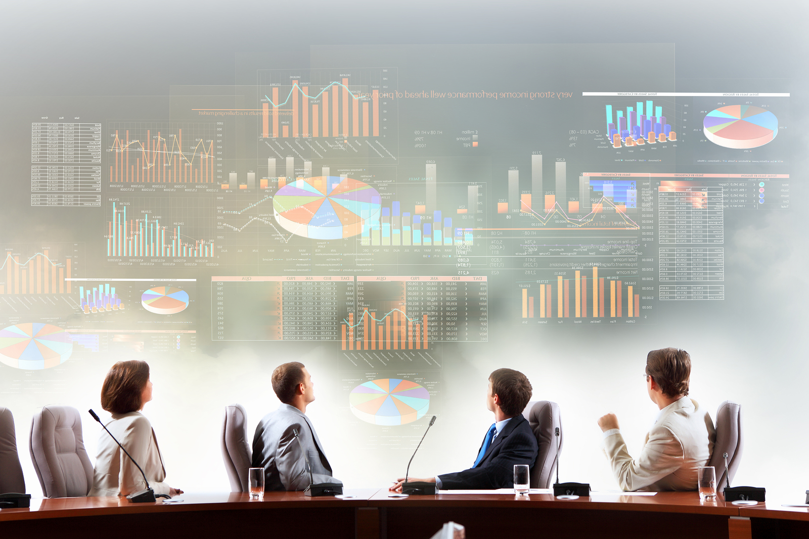 Business people sitting at a table looking at graphics