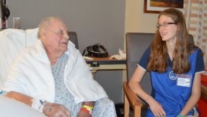Katie Wenger, a Springfield Hospital volunteer, talks with a patient.