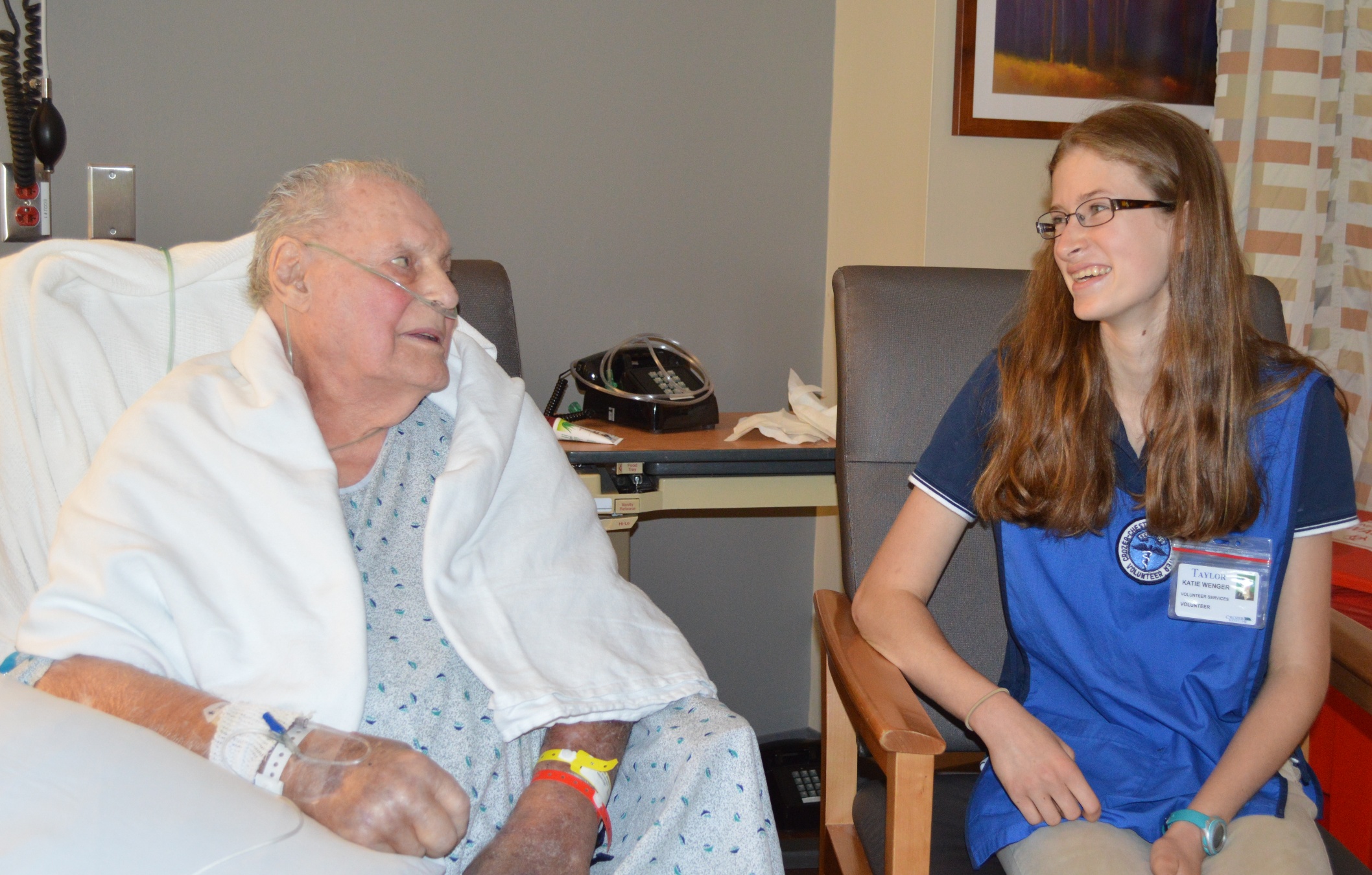 Katie Wenger, a Springfield Hospital volunteer, talks with a patient.