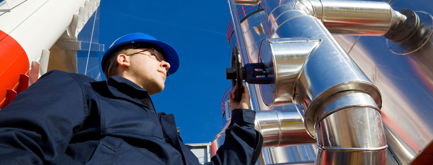 Man checking a piece of machinery.