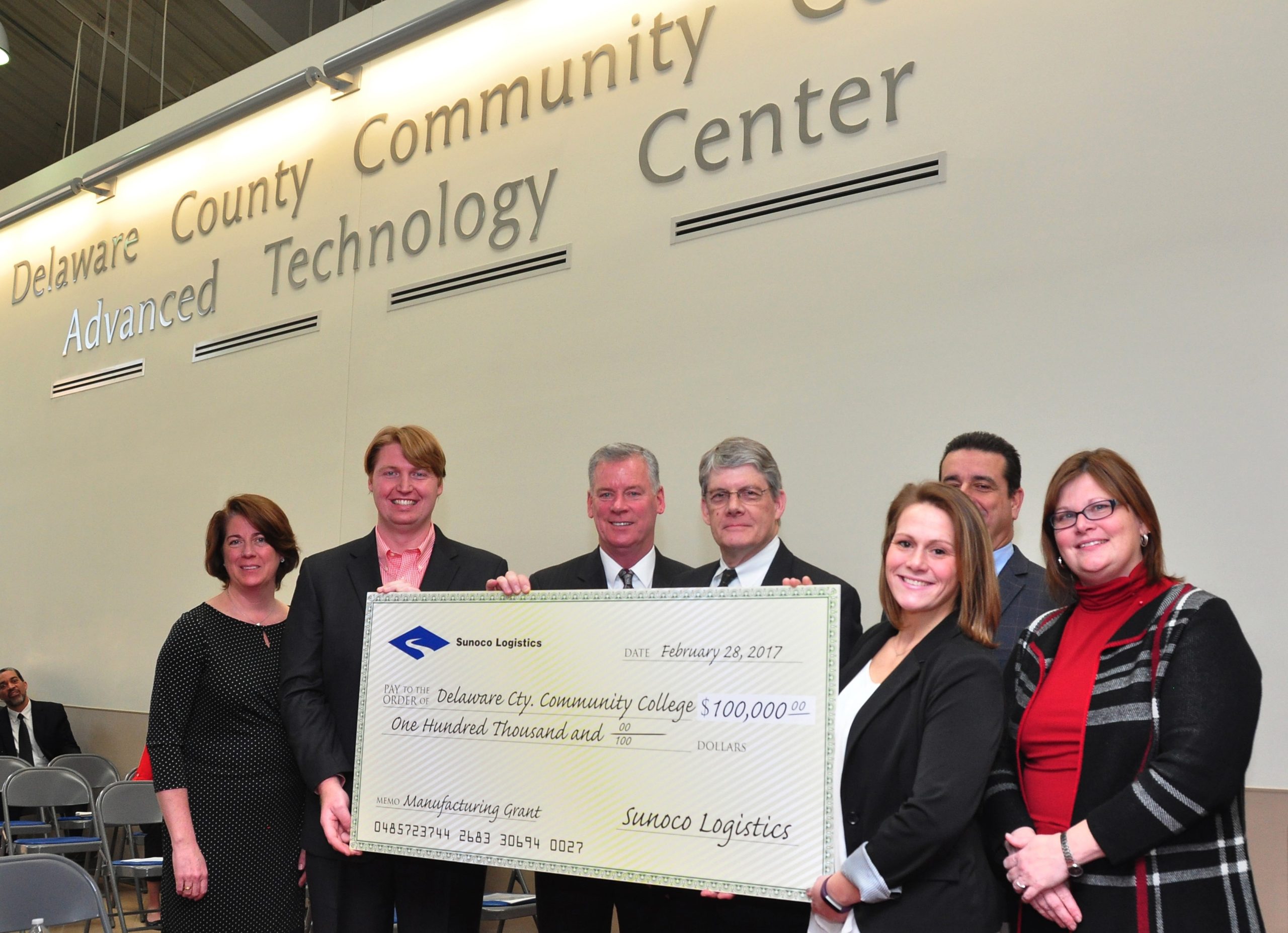 Sunoco check presentation with DCCC logo in the background.