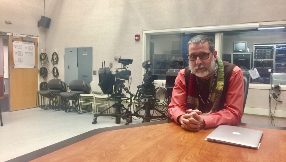 John Doyle sitting at a table.