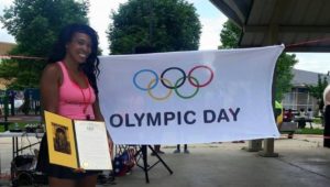 Jazmine Smith nex to an Olympic Day sign.