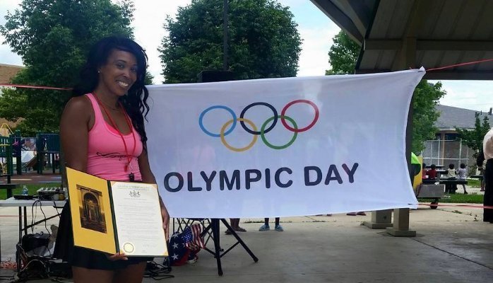 Jazmine Smith nex to an Olympic Day sign.