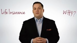 A dressed up man behind a wall that says "Life Insurance Why?"