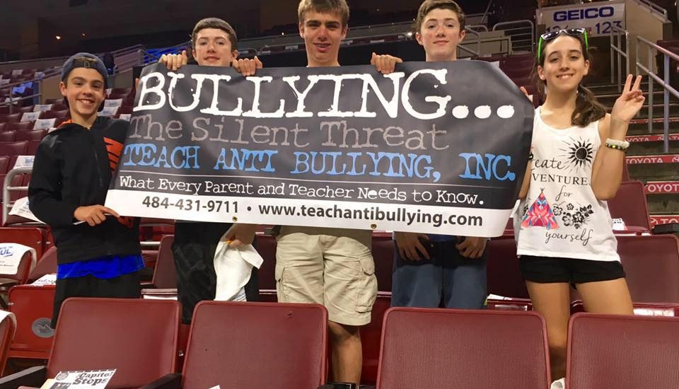 Students holding an anti-bullying bannar.