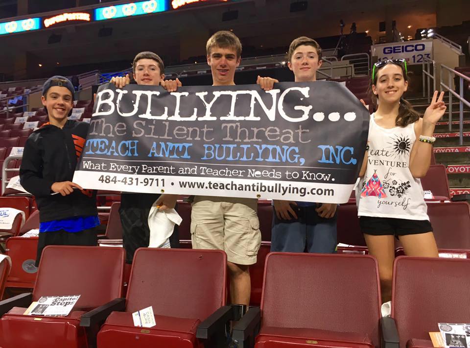 Students holding an anti-bullying bannar.