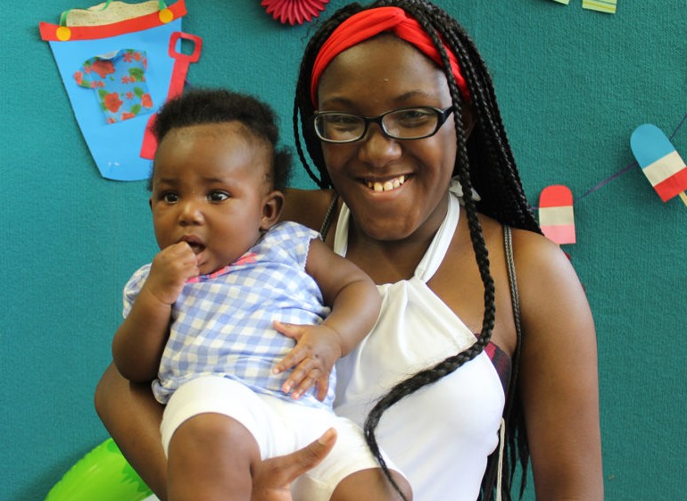 A mother holds her child.