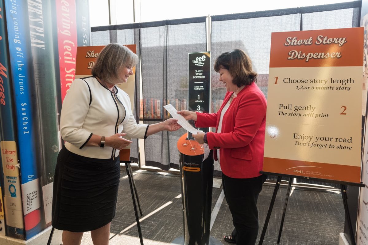 A woman has her ticket checked at a Philadelphia International Airport gate.