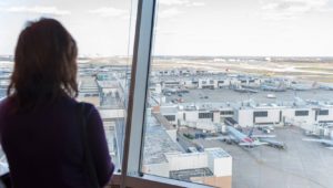 Woman looking out at parked planes at Philadelphia International Airport