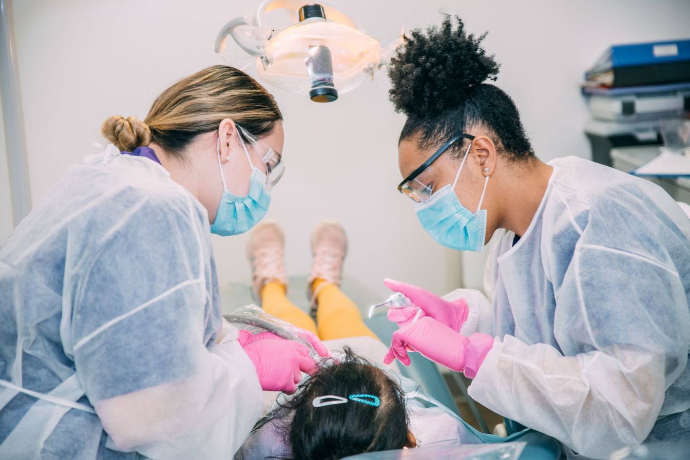Dental Hygiene students working with a pediatric patient.