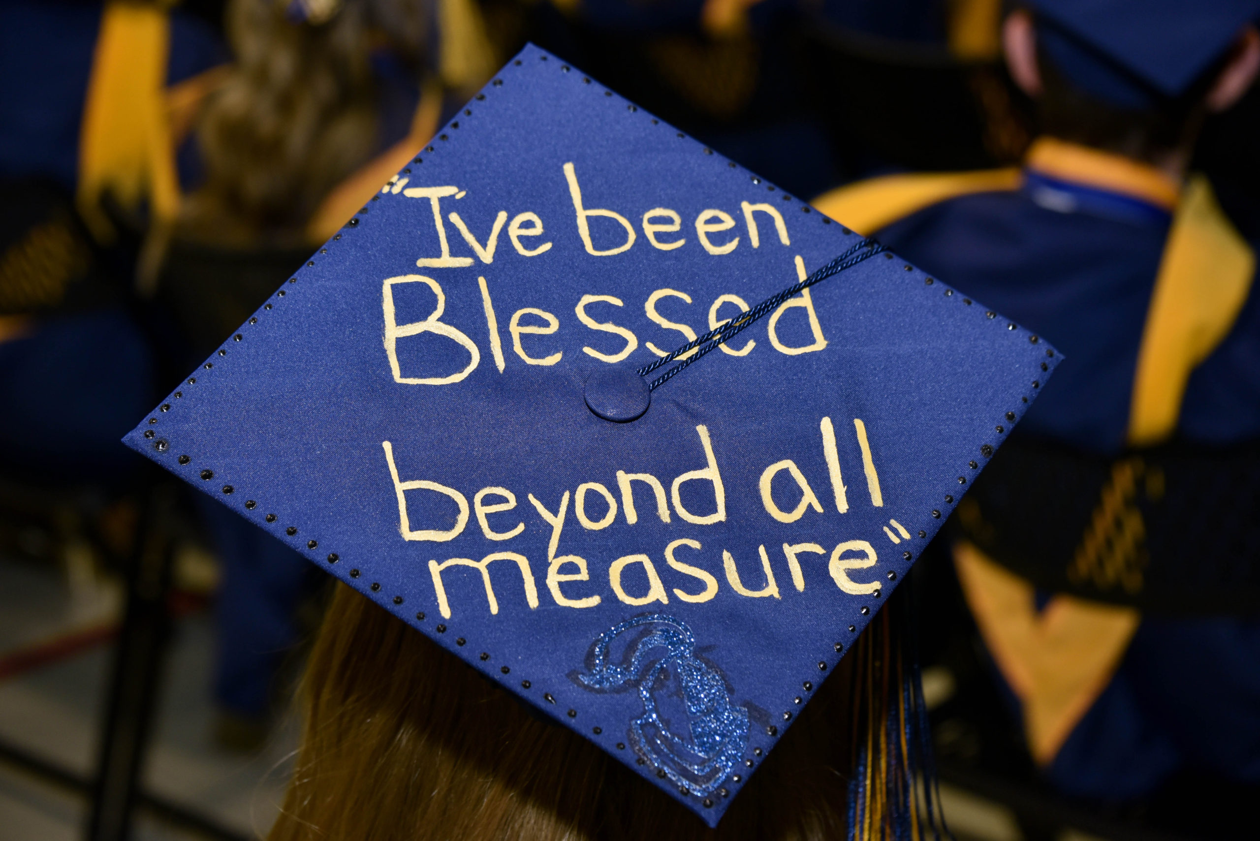 Neumann Graduates Display Humorous and Inspirational Mortarboard Messages at Ceremony