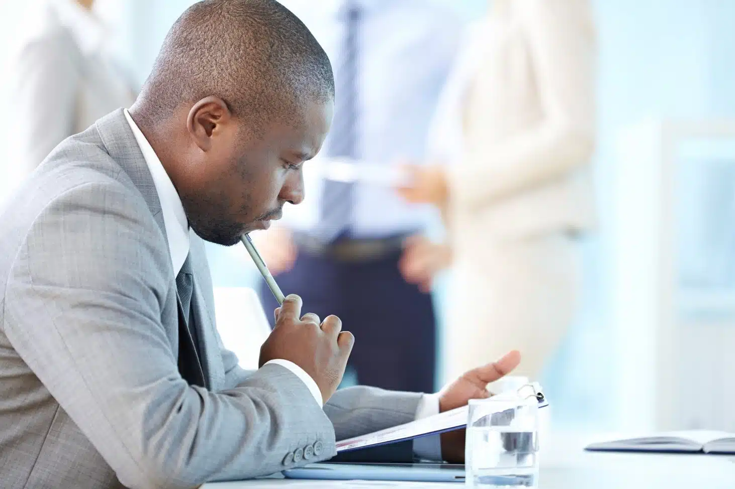 A man sitting looking at something deep in thought.