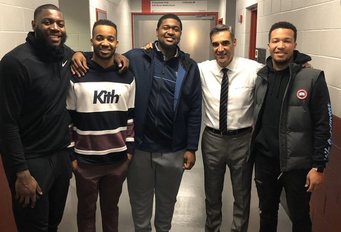 Jay Wright with members of his Villanova basketball team.