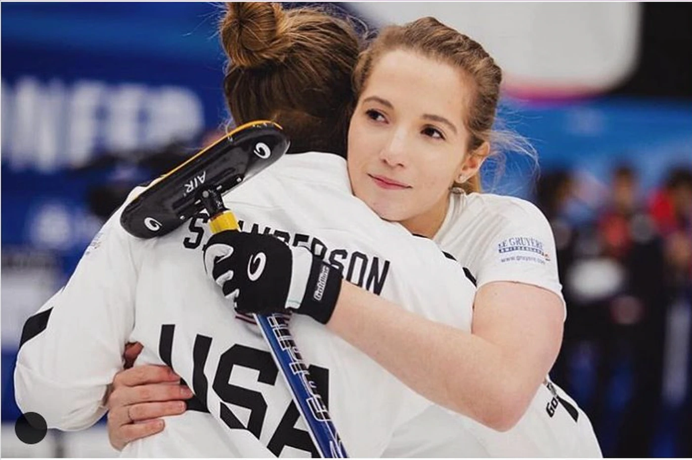 Taylor Anderson hugs her twin sister, Sarah, during a curling competition.