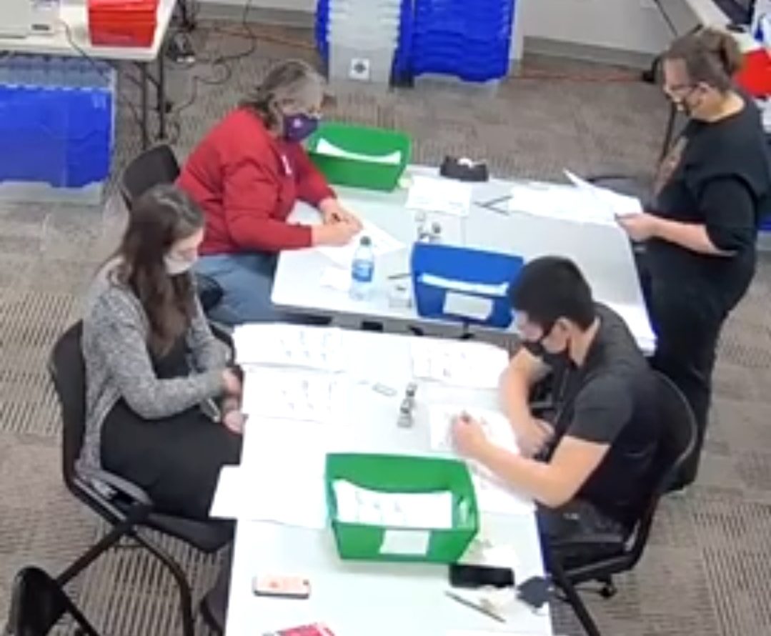 Ballot counters in the foreground are being watched by bipartisan observers at another table in this live feed screenshot from the Delaware County Bureau of Elections.