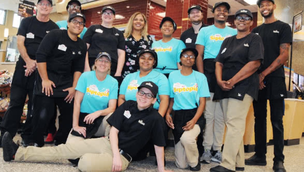 A diverse team of Wawa workers gathered in a group.