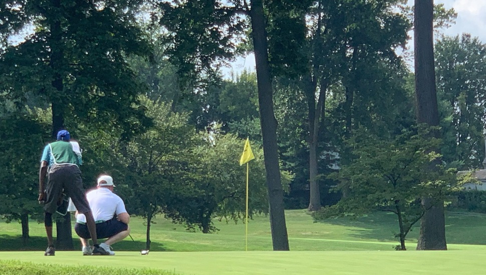 Caddy taking out the winning shot at Rolling Green Country Club.