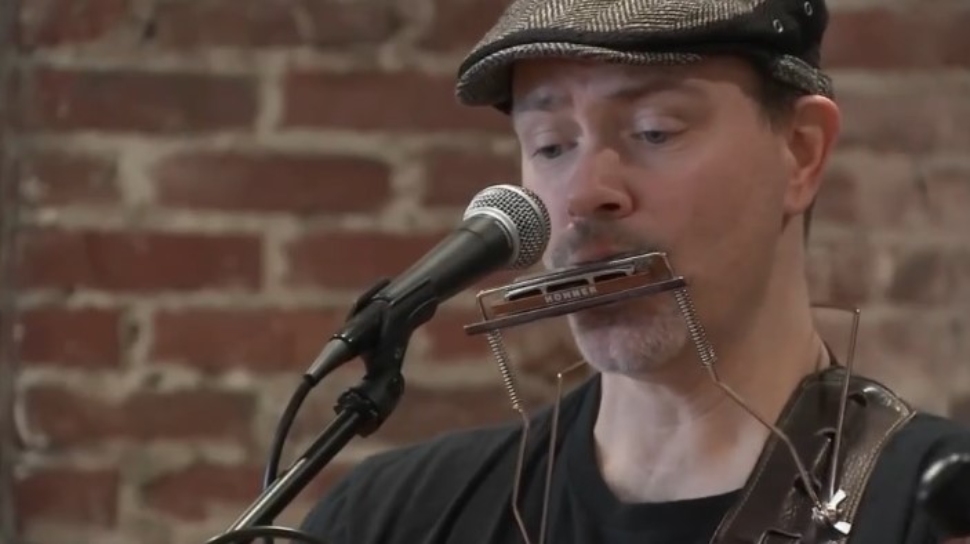 Singer playing a harmonica at the Kelly Center in Havertown