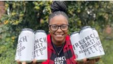 Charisse McGill holding cans of her French Toast Bites Ale