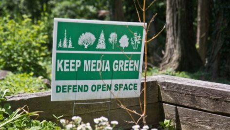 A sign protests a loss of open space in Media Borough