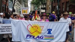 Marching in a Pride parade in 2018 are Barbara Klinman (in straw hat) and husband Michael.