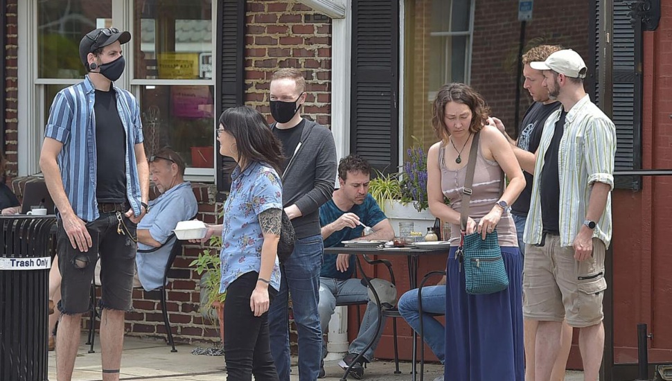 A scene of almost normal with masks and no masks outside the Corner Restaurant in Media.