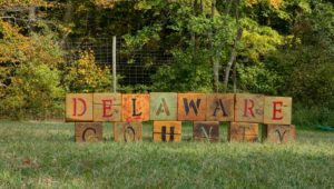Delaware County spelled out in blocks on a lawn.