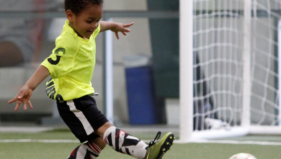 Kids play a little soccer at a SWAG activity.