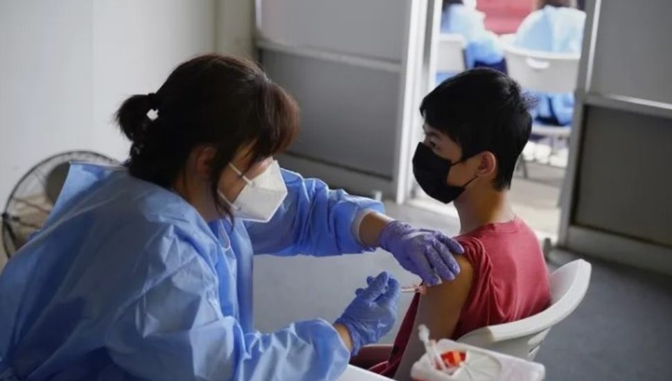 Nurse Hyun Lee administers a COVID-19 vaccine to Stephen Zeng, 15, of Northeast Philadelphia