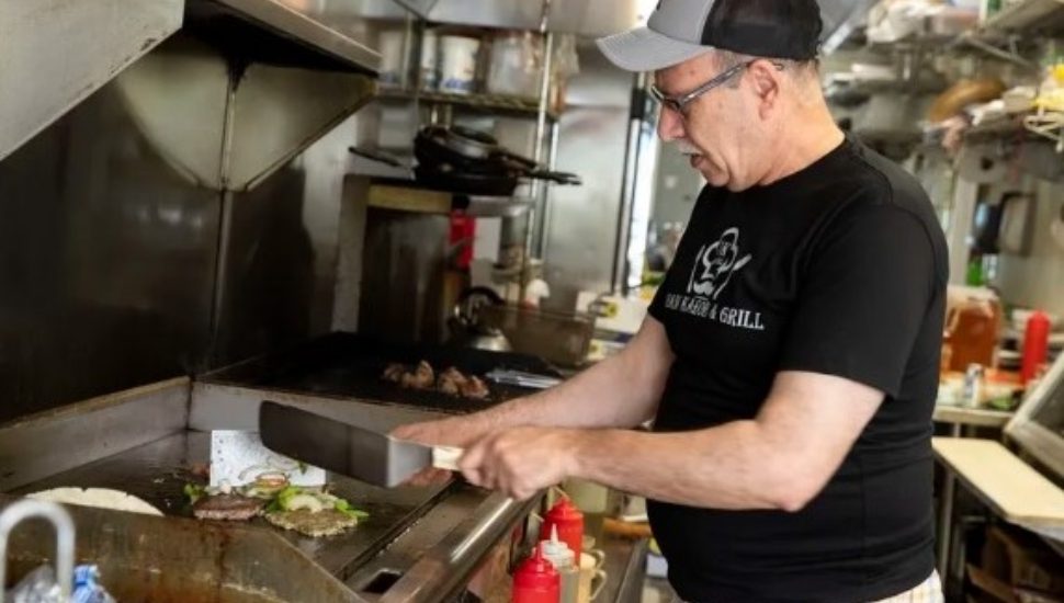 Owner Abdul Qayum works in his restaurant. He came to the US at age 21 but still has extended family in Afghanistan.