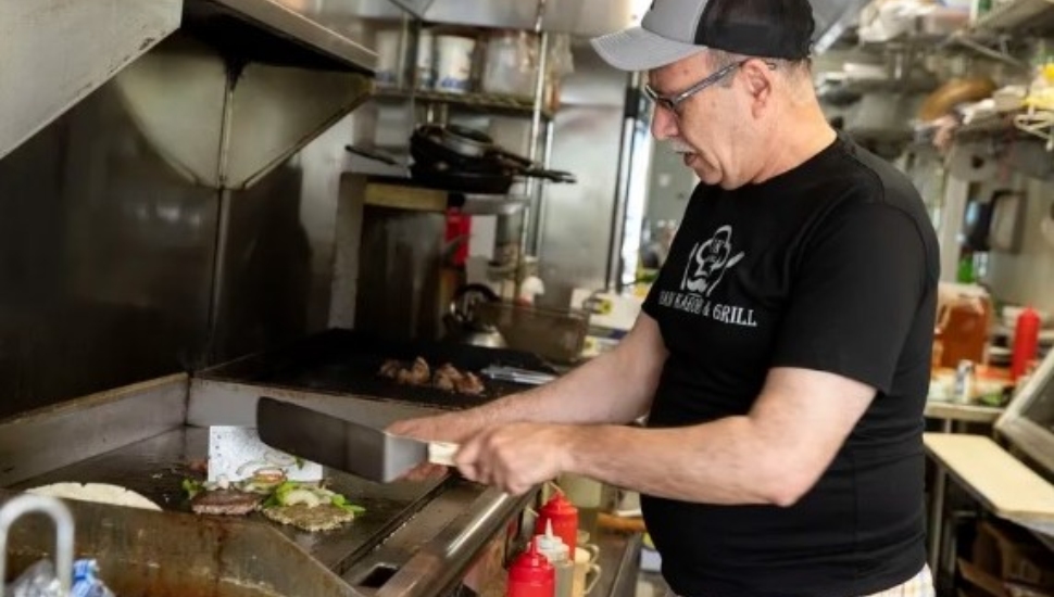 Owner Abdul Qayum works in his restaurant. He came to the US at age 21 but still has extended family in Afghanistan.