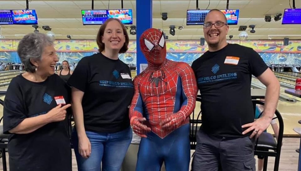 Volunteer Lois Bowman of Glenolden (left), with Amanda McGuigan of Ridley Township, Delco Spiderman, and Scott Andersen of Ridley Township at a Keep Delco Smiling Bowling Day event.