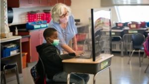 Second grade student Jaiden West, 8, with his teacher Bonnie Spears-Benedetto at Barry Elementary School in Philadelphia, The delta variant makes may alter school mask plans.