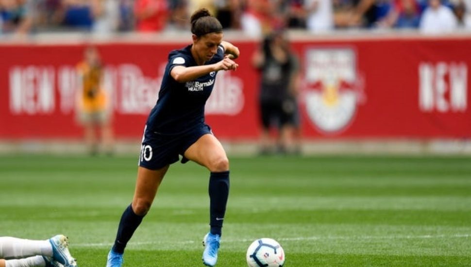 Carli Lloyd runs with the ball at a 2019 soccer game in Harrison.
