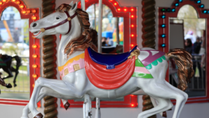 A colorful house on a carousel.