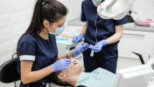 Dental Hygienists working with a patient