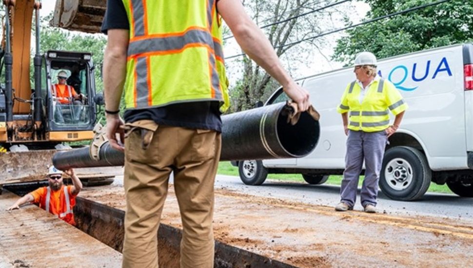 utility workers installing water pipe