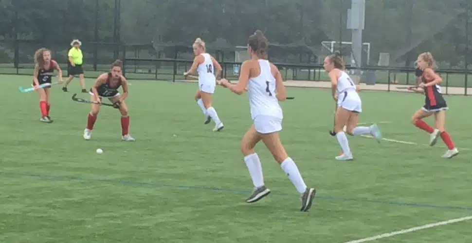 The field hockey squads of Archbishop Carroll and Cardinal O'Hara on the field at a game.