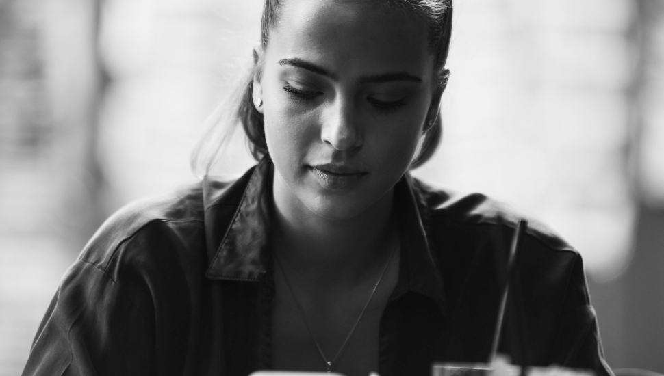 woman alone looking at her phone