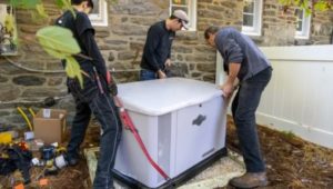 Technicians install a standby generator at an Upper Providence home.