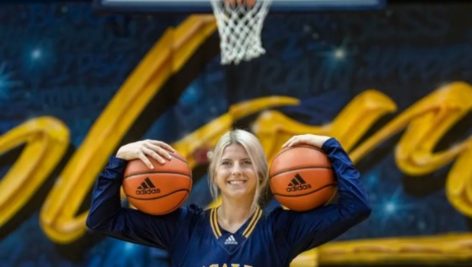 Molly Masciantonio holding two basketballs at La Salle University.